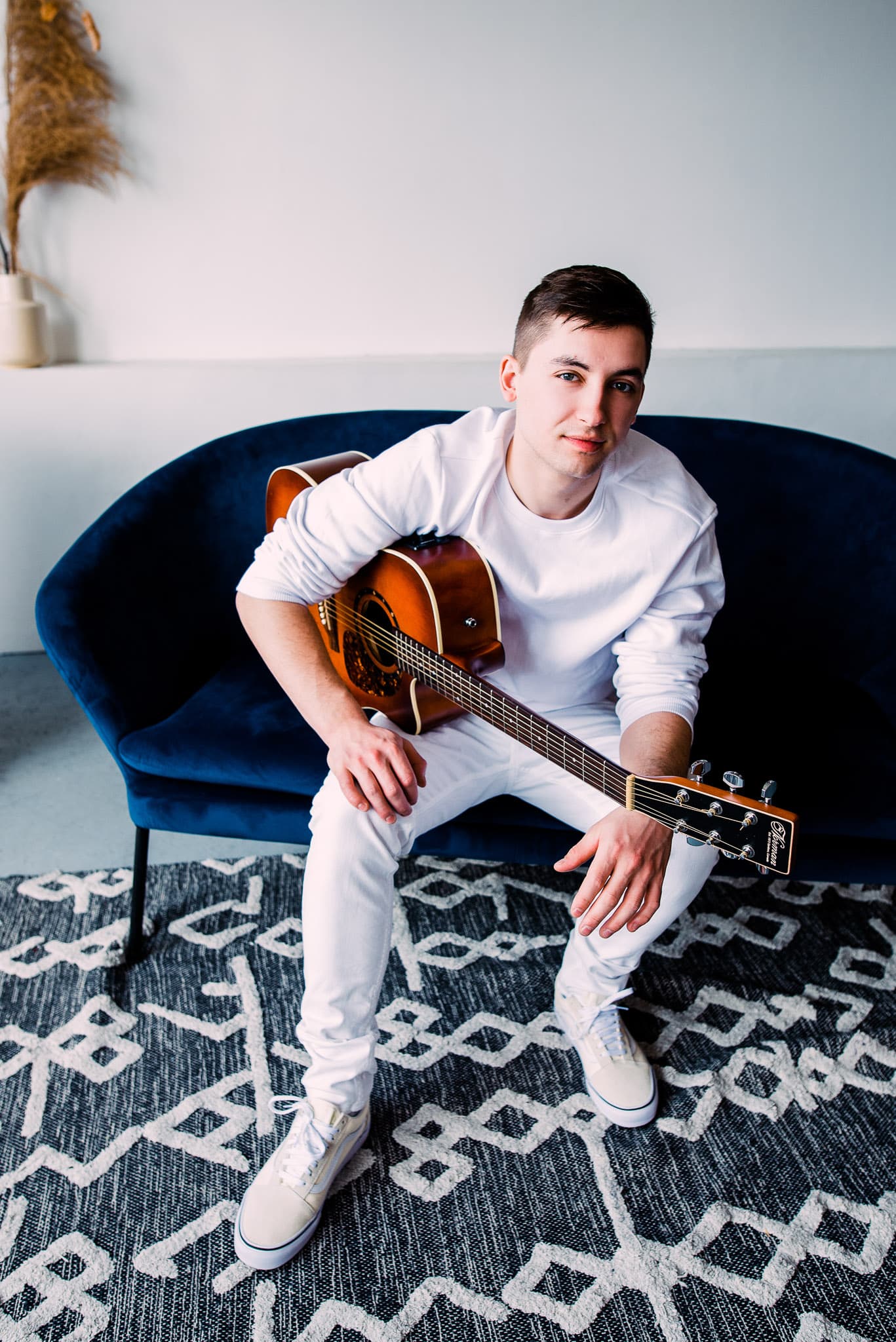 A profile image of Davin Chiupka sitting with a guitar